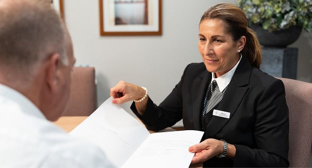 funeral director shaking hands with woman